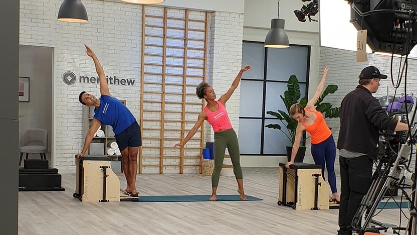 Jennifer Dahl, a Merrithew Connect presenter, teaches two other instructors Pilates during a video shoot for the online workout platform