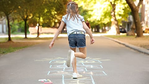 Kid playing hopscotch