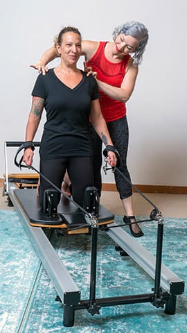 Magda working with client on Reformer