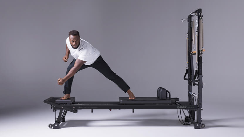 Man stretching on new V2 Max Reformer - Jet Black